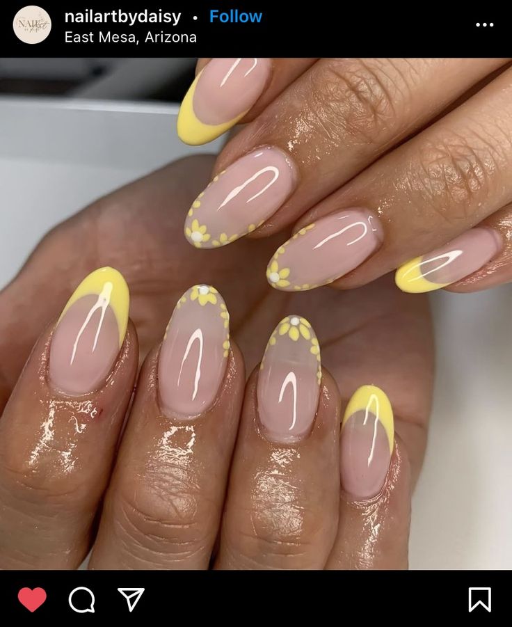 Cheerful Nail Design: Bright Yellow Tips and Floral Accents on Soft Pink Base.