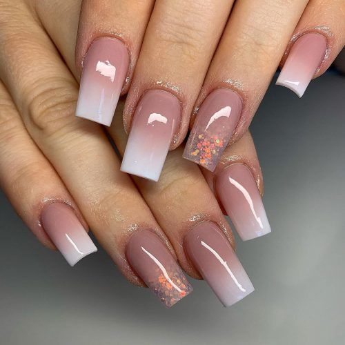 Sophisticated Ombre Nail Design: Soft Pink to Crisp White with Glitter Accents.