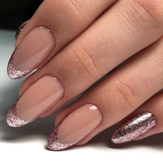 Chic and Sophisticated: Elegant Nude Nails with Pink Glitter French Tips and Full Glitter Accent.