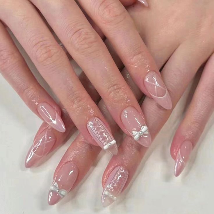 Chic Soft Pink Nail Design with Elegant White Accents and Intricate Patterns