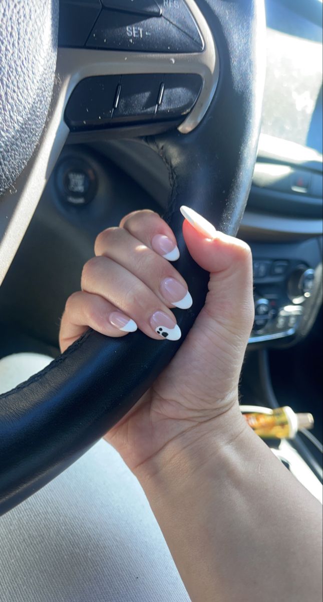 Chic French Manicure with Playful Accents and Minimalistic Design.