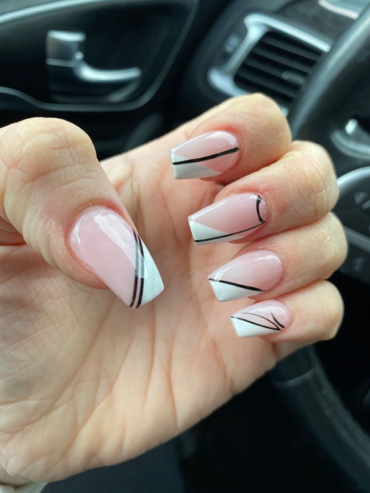 Chic Modern Nail Design: Subtle Pink Base with Striking White Tips and Elegant Black Accents.