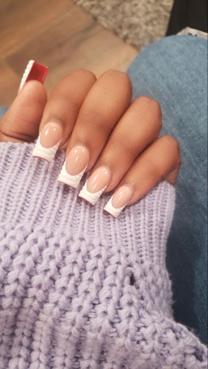 Chic Contemporary French Tip Nail Design with Bold White Tips and Eye-Catching Red Accent.