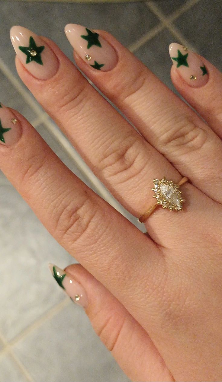 Elegant Nude Nail Design with Vibrant Green Stars and Subtle Gold Accents