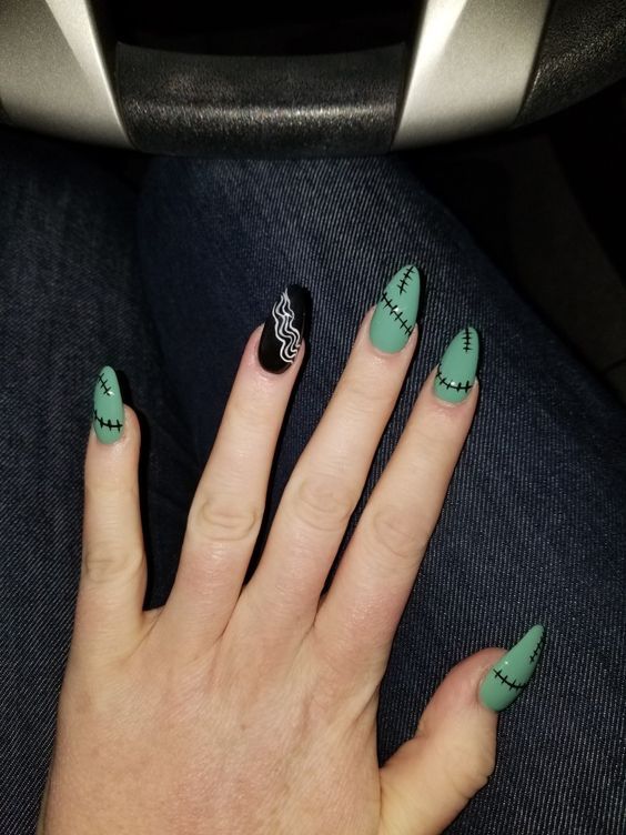 Eclectic Mint Green and Black Nail Design with Stitched Patterns and Wavy Accent.