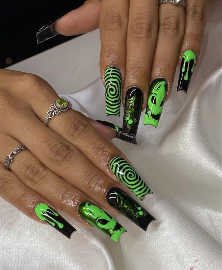 Bold Black and Neon Green Futuristic Nail Design with Intricate Patterns and Dramatic Elongation.