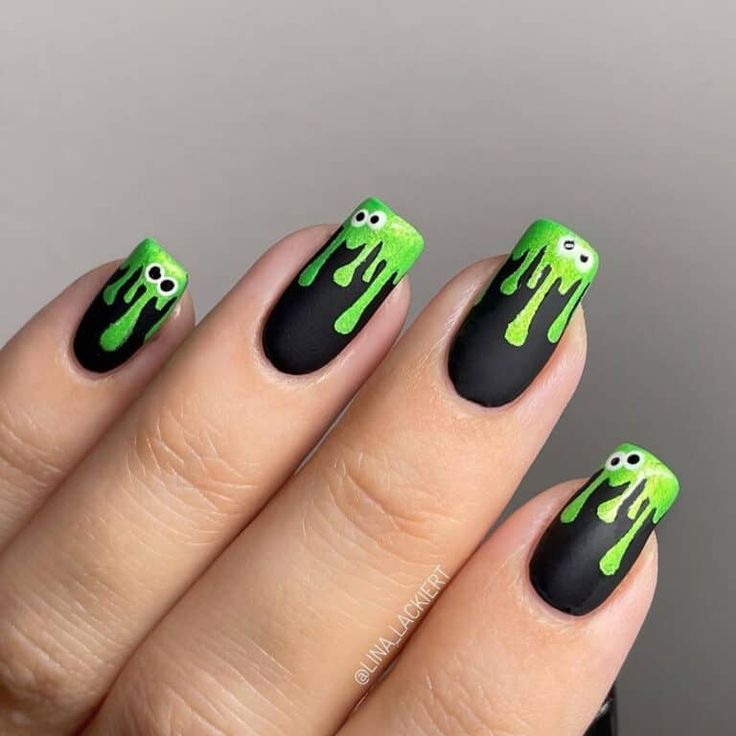 Spooky Green Drip Nail Design with Playful Eyes for Festive Occasions