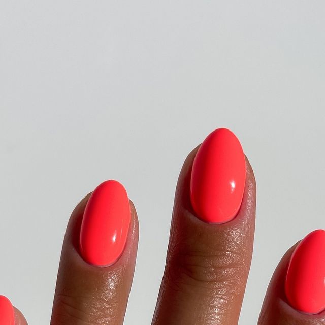 Bold Neon Pink Oval Nails: A Playful and Elegant Summer Statement.