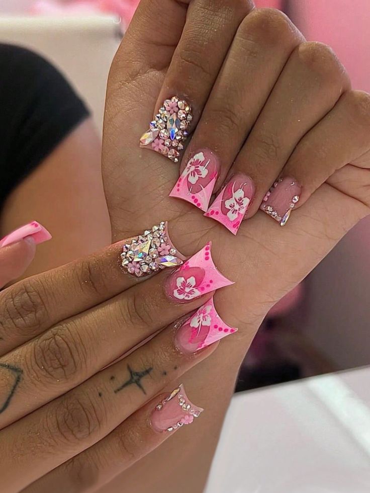 Vibrant Pink Floral Nail Design with Rhinestones: A Playful yet Elegant Look.