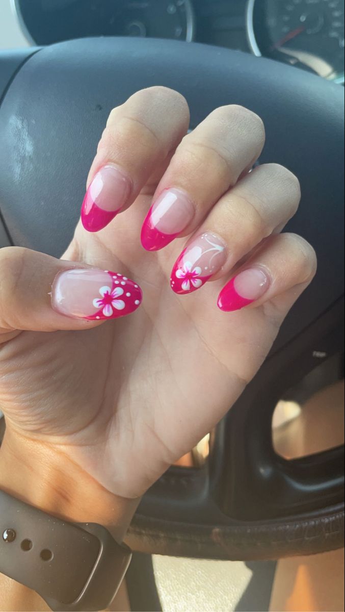 Cheerful Vibrant Pink French Tips with White Floral Accents for a Whimsical Summer Nail Aesthetic.