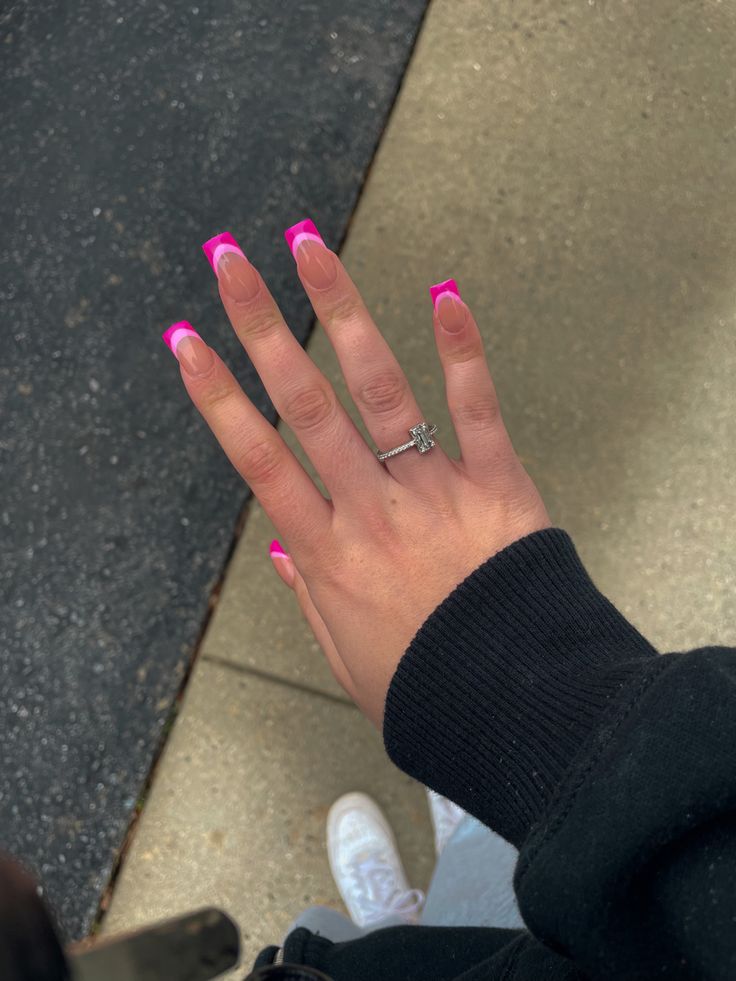 Chic Pink French Tip Nails and Delicate Silver Ring Create a Stylish Statement.