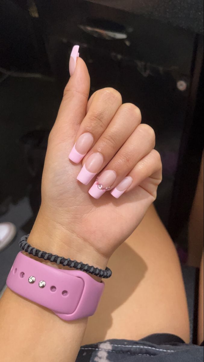 Chic Soft Pink Nail Design with Modern French Tips and Delicate Accents.