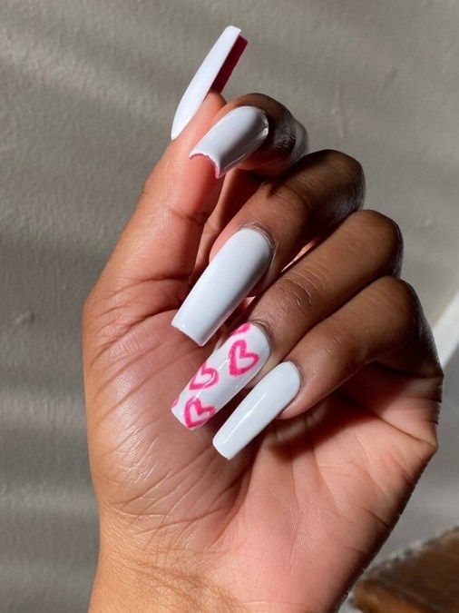 Playful Elegant White Nails with Charming Pink Heart Design for a Modern Aesthetic.