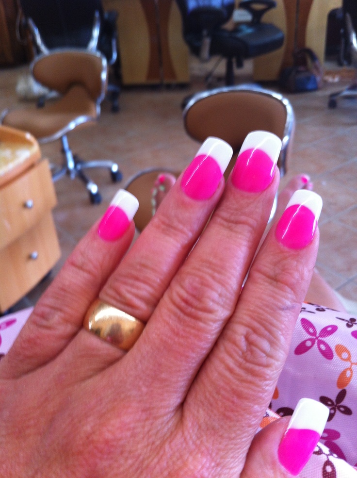 Vibrant Pink French Manicure with Gold Accents: A Chic and Playful Style.