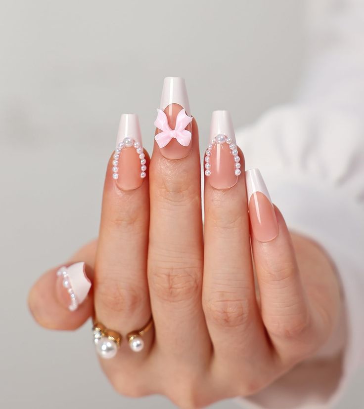 Sophisticated Nail Design: Soft Pink French Tips with Pearls and a Bow