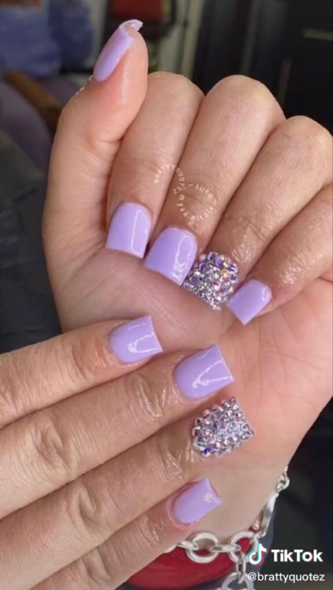 Chic Lavender Acrylic Nails with Glamorous Rhinestone Accents for a Stylish Statement.