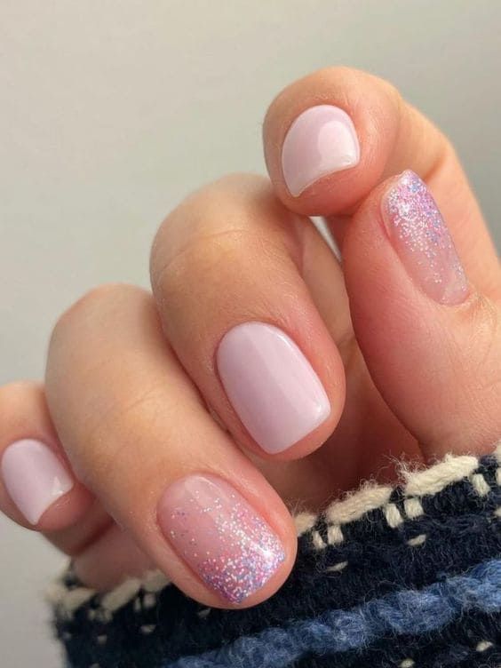 Chic Pastel Lavender Manicure with Glitter Accents for Subtle Elegance.