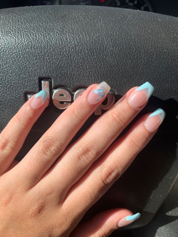 Elegant Soft Blue French Tip Nails with Unique Detailing.