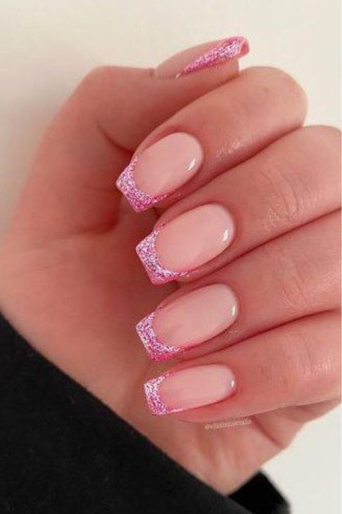 Elegant Nude Base with Sparkling Pink French Tips for a Modern Nail Design