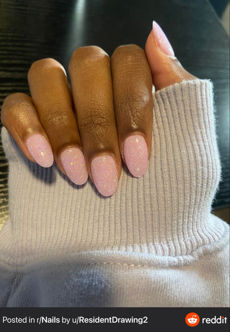 Elegant Almond-Shaped Nails with Soft Pink Polish: A Chic Blend of Glamour and Sophistication.