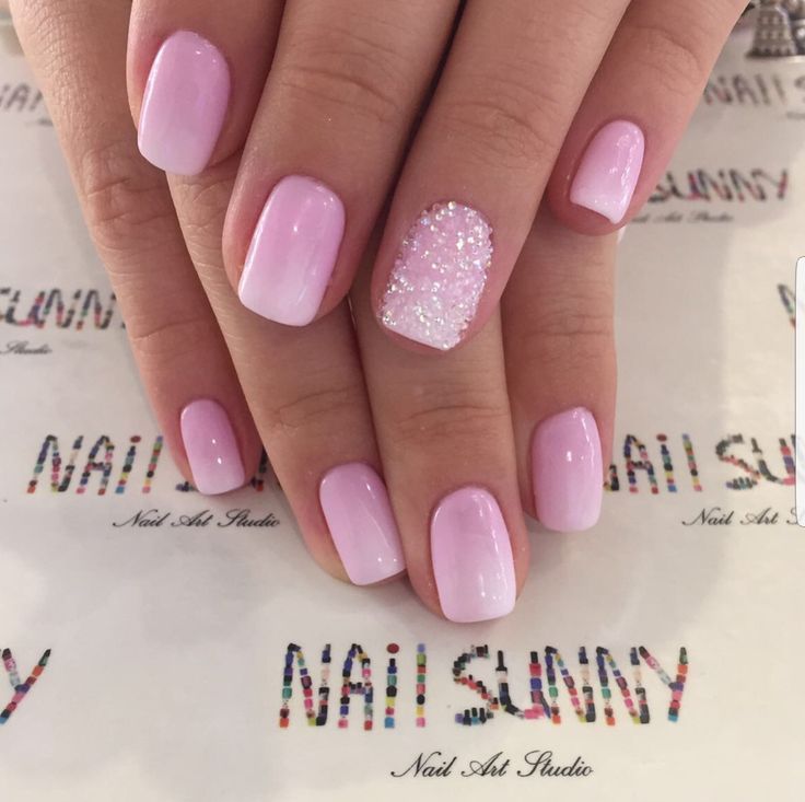 Glamorous Soft Pink Gradient Nail Design with Glitter Accent.