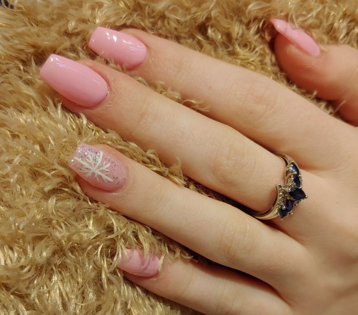 Chic Soft Pink Nail Design with Shimmering Snowflake Accent and Elegant Ring