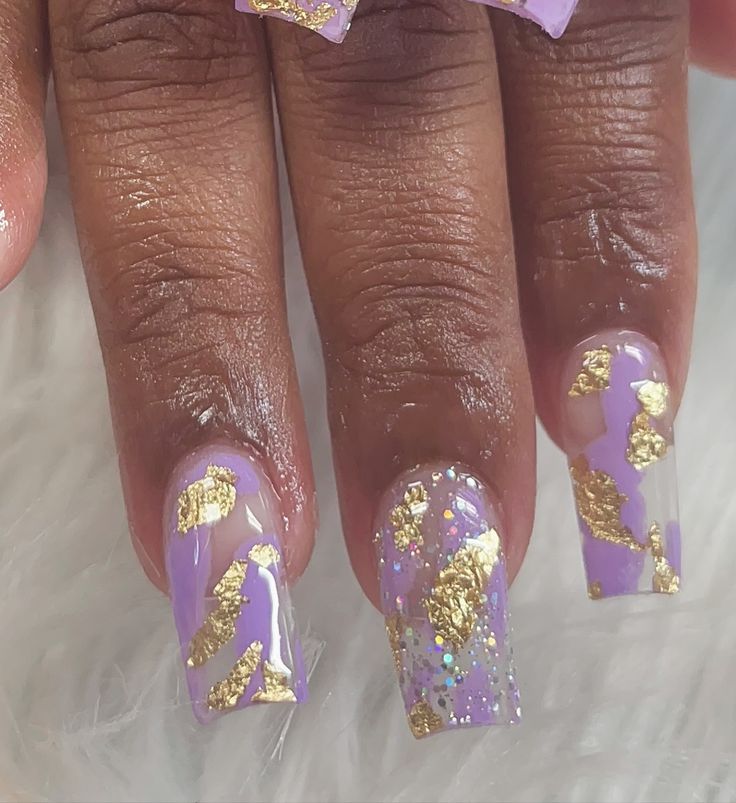 Luxurious Lavender Nail Design with Glossy Textures and Gold Foil Accents.