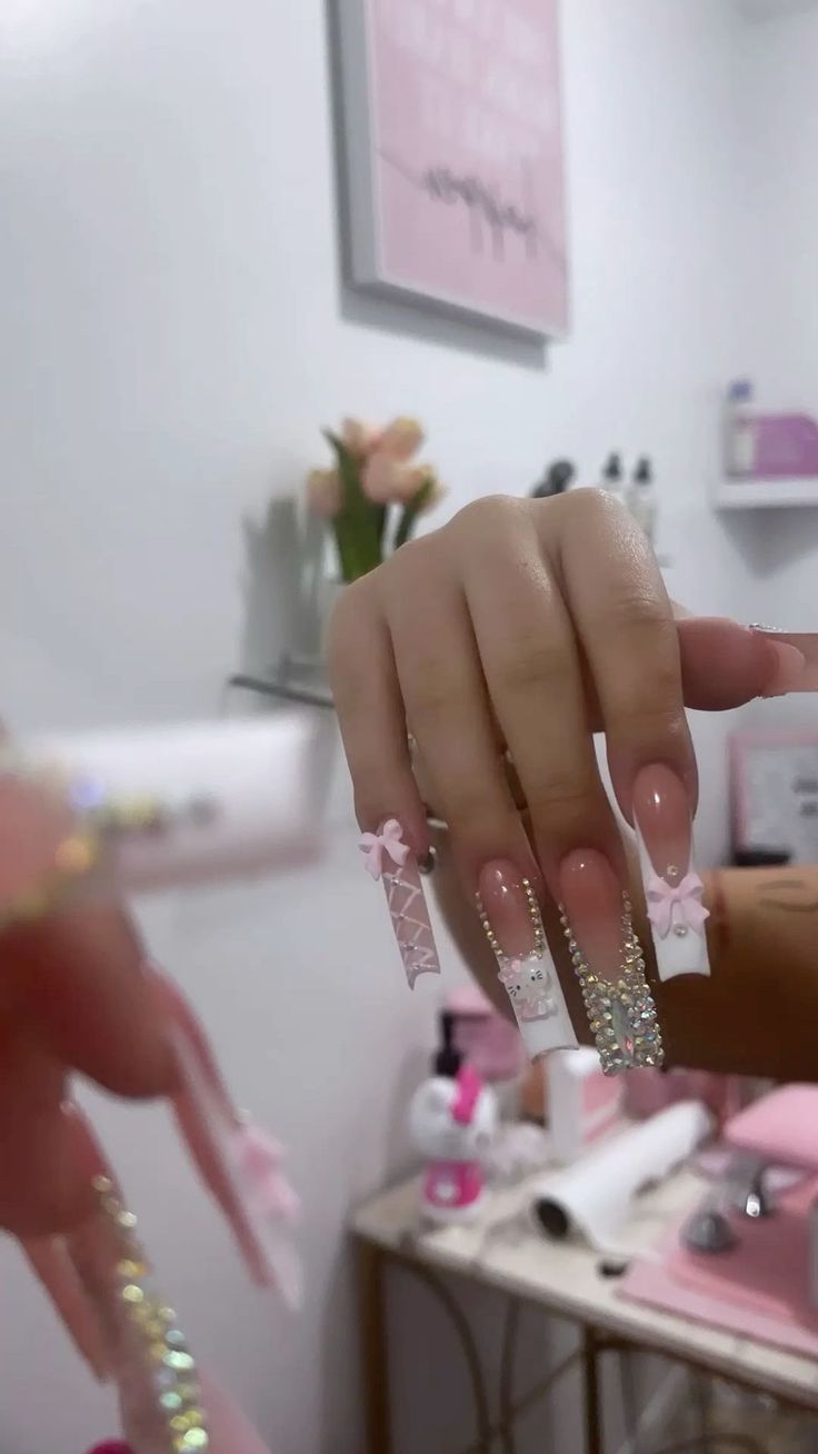 Playful and Elegant Nail Design with Soft Pink Base and Charming Accents.