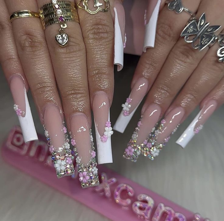 Chic Floral-Design Long Nails with Colorful Gem Accents for Elegant Occasions.