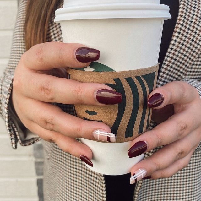 Chic Burgundy Nail Design with Geometric Accents and Modern White Details.