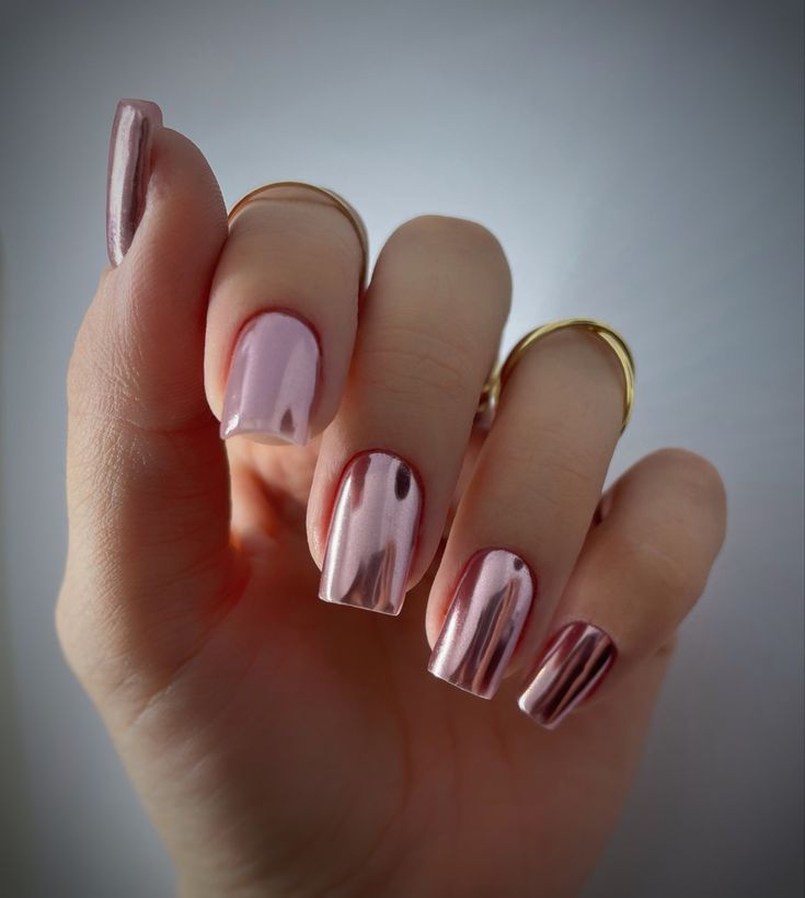 Elegant Shiny Metallic Nails with Soft Pink Gradient and Gold Ring Accents.