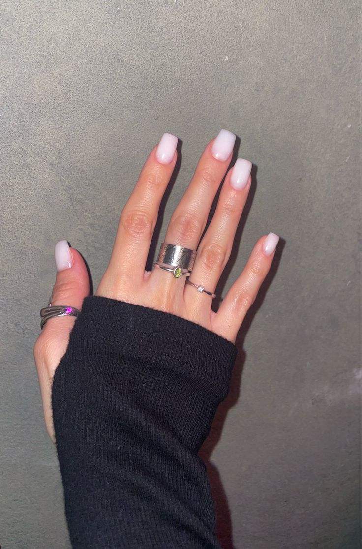 Chic Soft Pink Ombre Tips on Long Squared Nails with Silver Ring Accents.