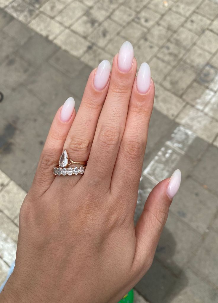 Sophisticated Almond-Shaped Nails with Ombre Pink Finish and Sparkling Accents.