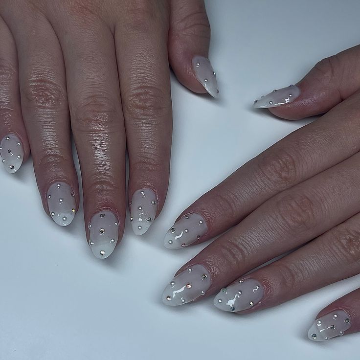 Chic Elegant Nail Design with Translucent Base and Pearl Embellishments