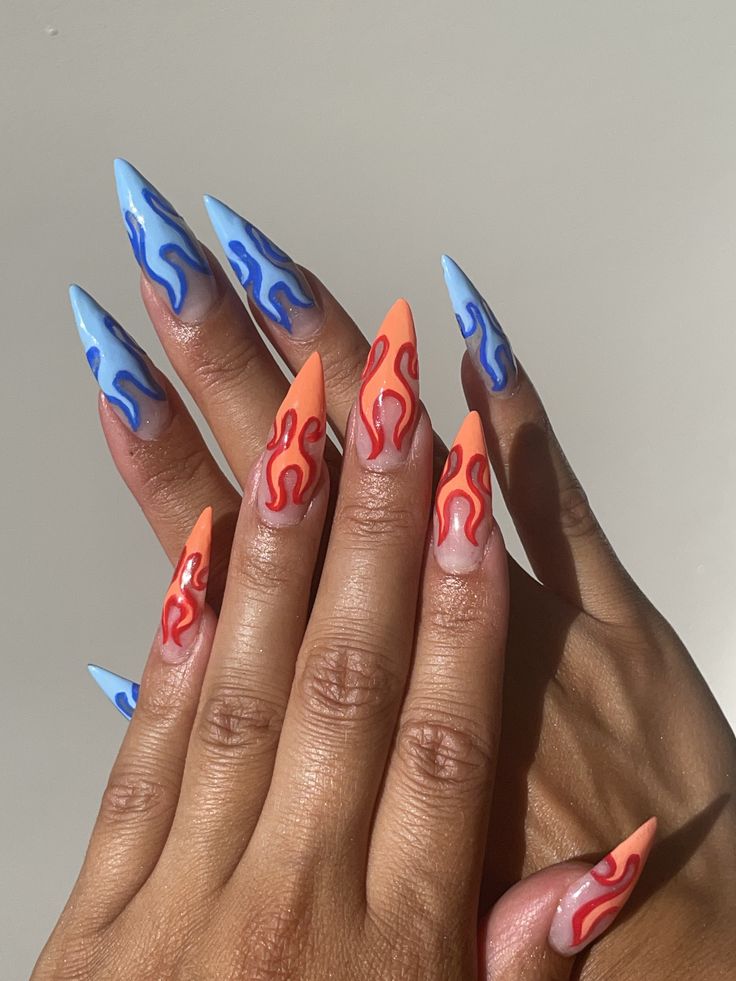 Bold Stiletto Nails: Vibrant Blue and Peach Design with Artistic Swirls and Playful Flame Motif.