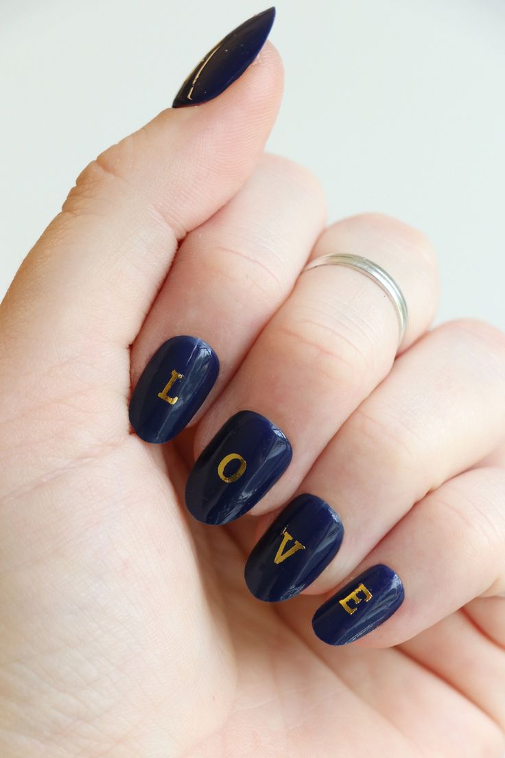 Chic Deep Navy Nail Design with Glossy Finish and Playful Typography.