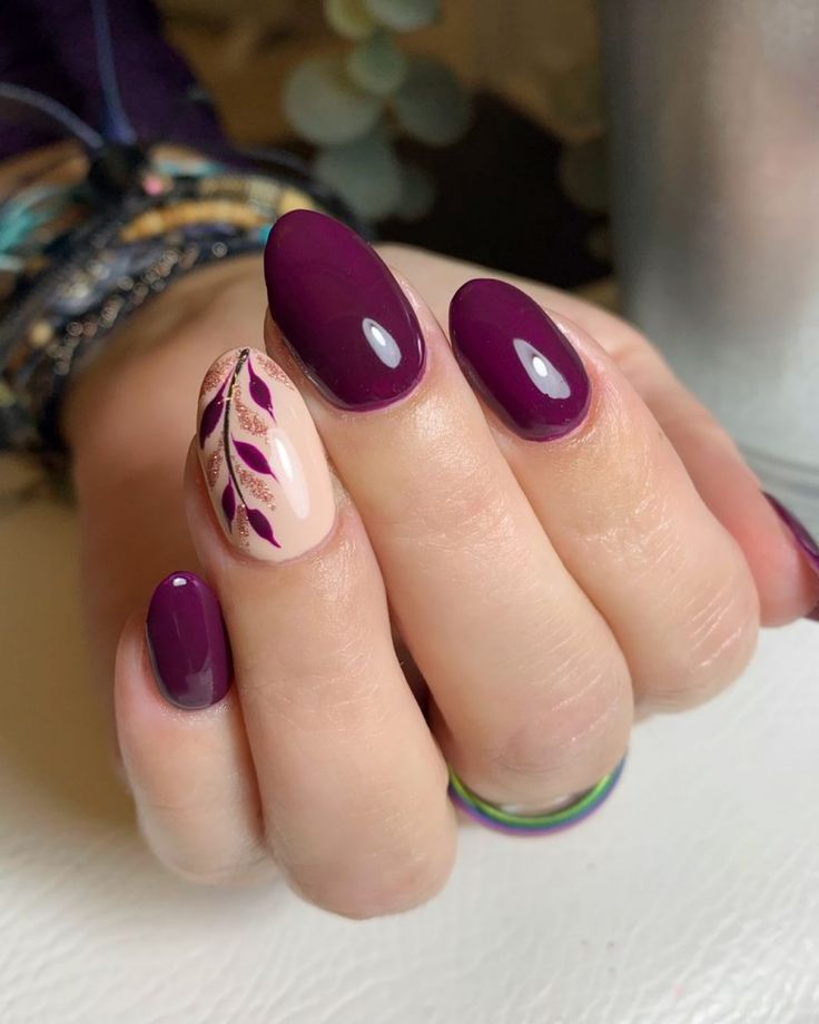 Elegant Plum Nail Design with Glossy-Matte Finish and Intricate Leaf Accents.