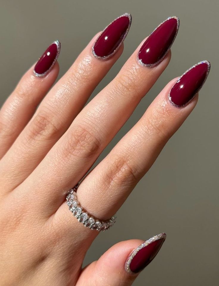 Chic Elegance: Almond-Shaped Nails in Deep Burgundy with Shimmering Silver French Tips.