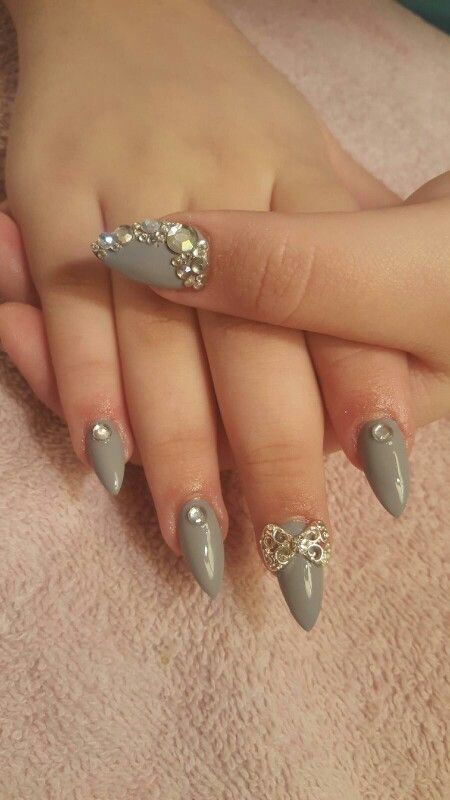 Sophisticated Gray Nail Design with Rhinestones and Bow Accents for Special Occasions.