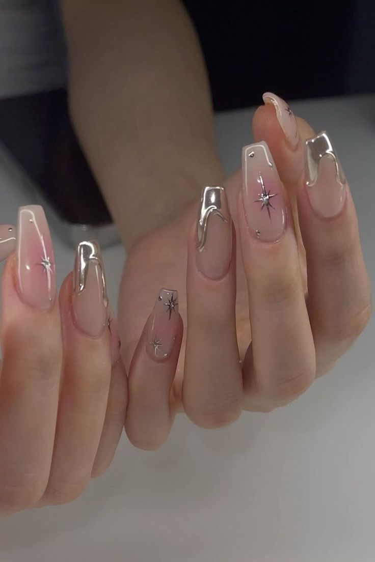 Chic Soft Pink Nail Design with Metallic Silver Tips and Star Accents.