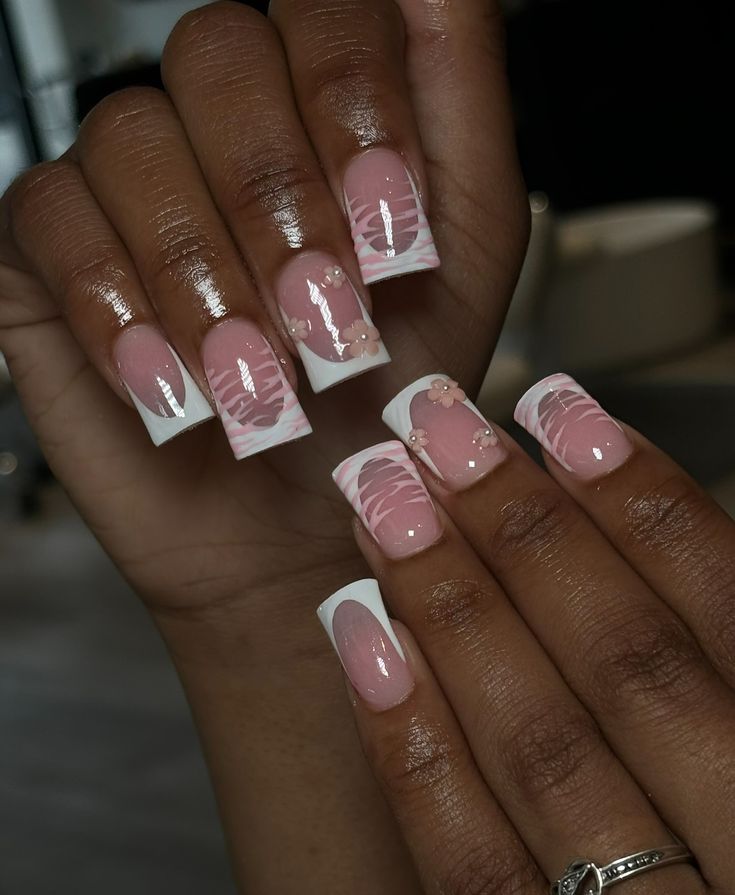 Sophisticated Soft Pink and White Nail Design with Artistic Swirls and Glossy Finish.