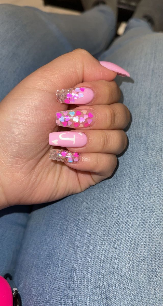 Chic Nail Design with Soft Pink Polish and Festive Sparkling Accents