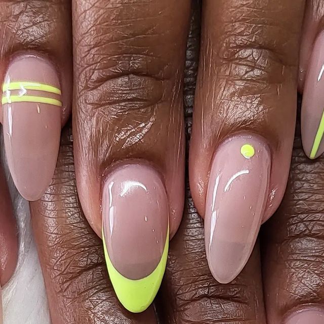 Chic Almond-Shaped Nails with Vibrant Yellow Accents on a Nude Base.