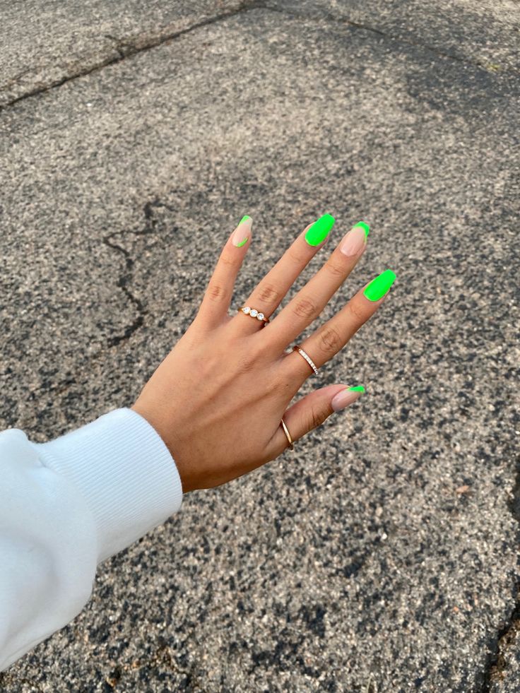 Chic Neon Green and Nude Manicure with Elongated Almond Shape and Delicate Rings.