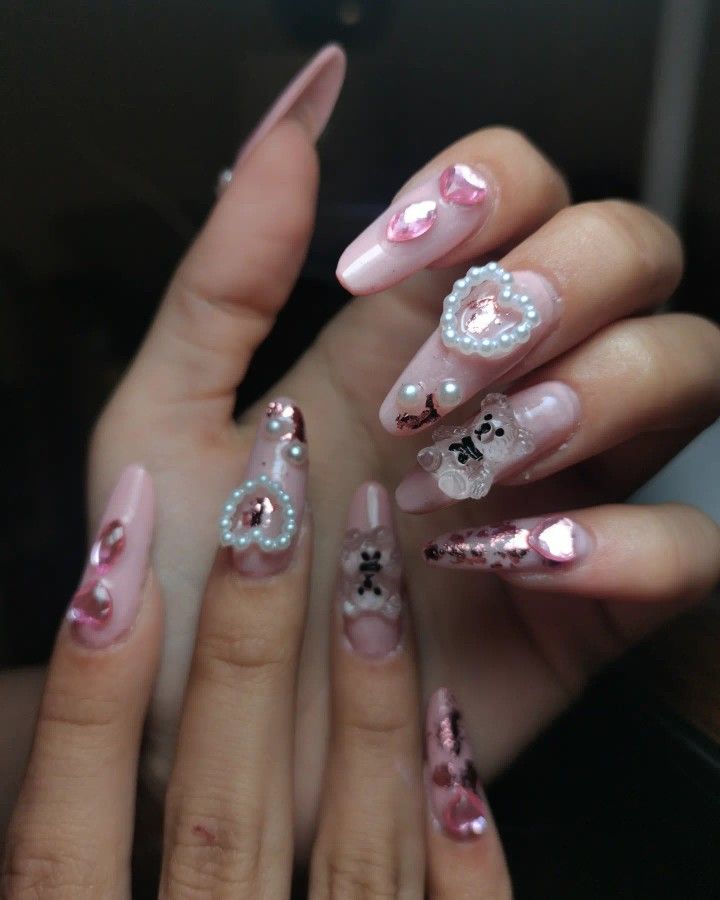 Romantic Soft Pink Nail Art with Intricate Embellishments and Elegant Accents.