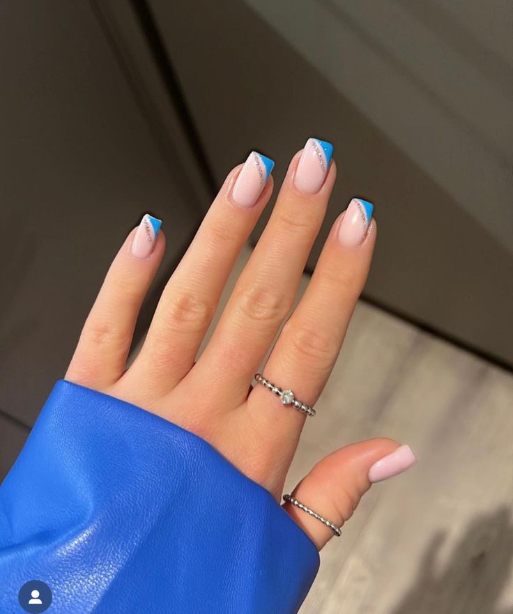 Chic Pink and Bold Blue Triangle-Tipped Manicure: Elegance Meets Playfulness.