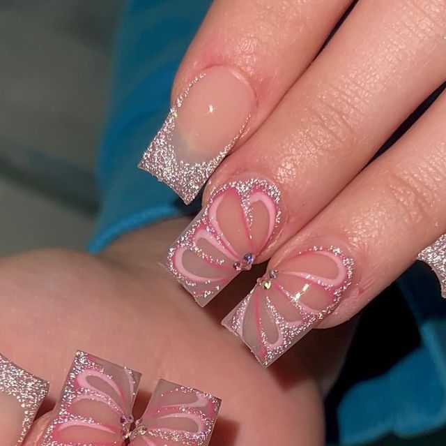 Whimsical Butterfly Nail Art: Elegant Pink Base with Glitter Tips and Gem Accents