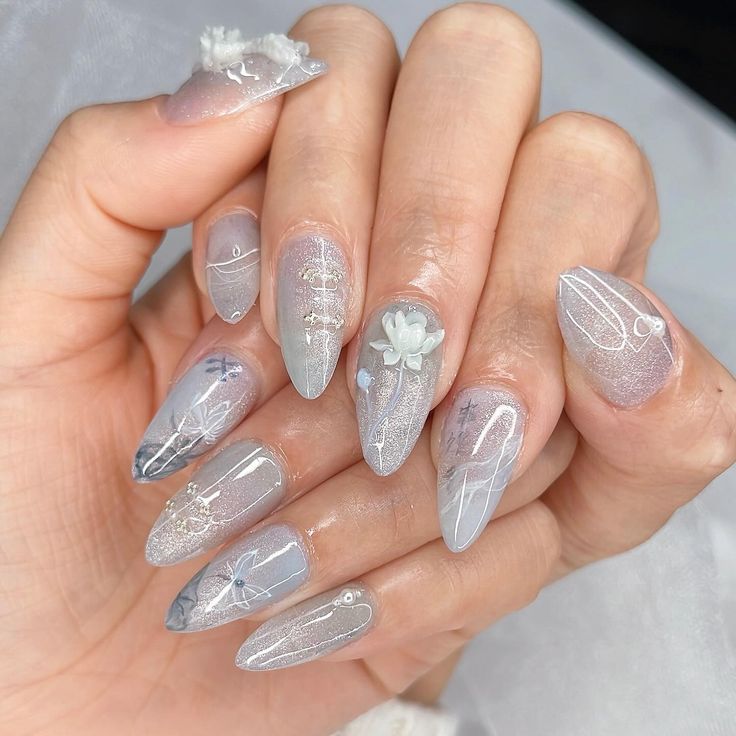 Sophisticated Almond-Shaped Nail Design with Soft Gray, Translucent Shades, and Floral Patterns