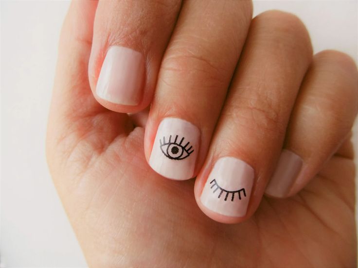 Minimalist Eye Motif Nail Art: Modern Aesthetic with Simple Black Accents.