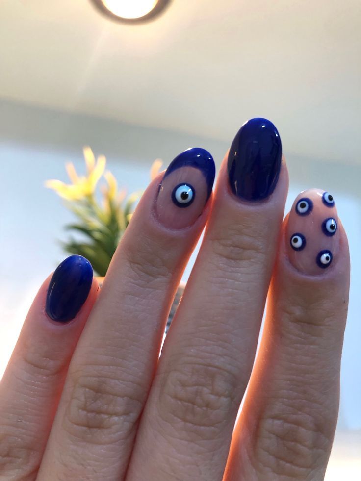 Playful Eye Motif Blue Nail Design with Glossy Finish